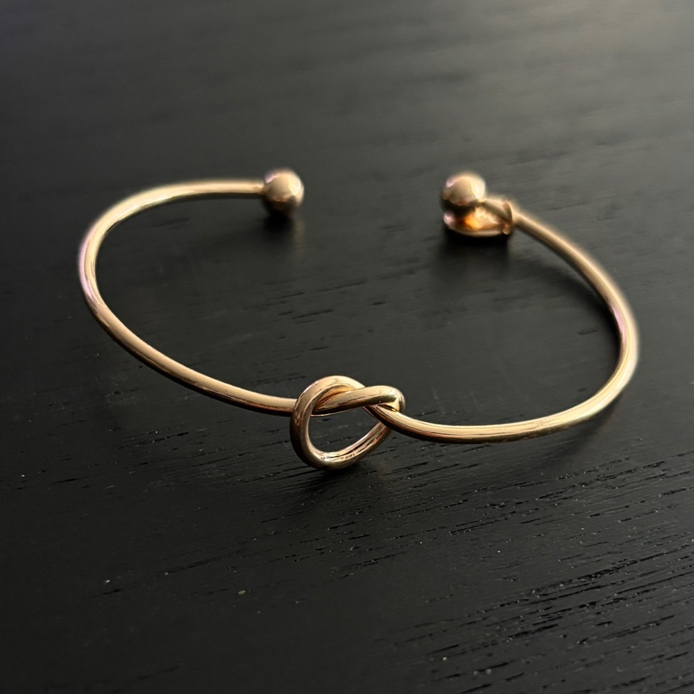 Brand new gold plated knot bangle